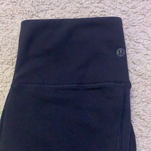 Black Lululemon tights with flower pattern on legs